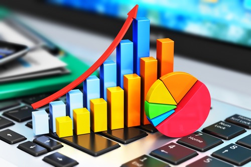 Creative abstract mobile office, stock exchange market trading, statistics accounting, financial development and banking business concept: color growth bar chart and pie diagram on modern laptop or notebook computer PC keyboard and other still life stationery supplies with selective focus effect